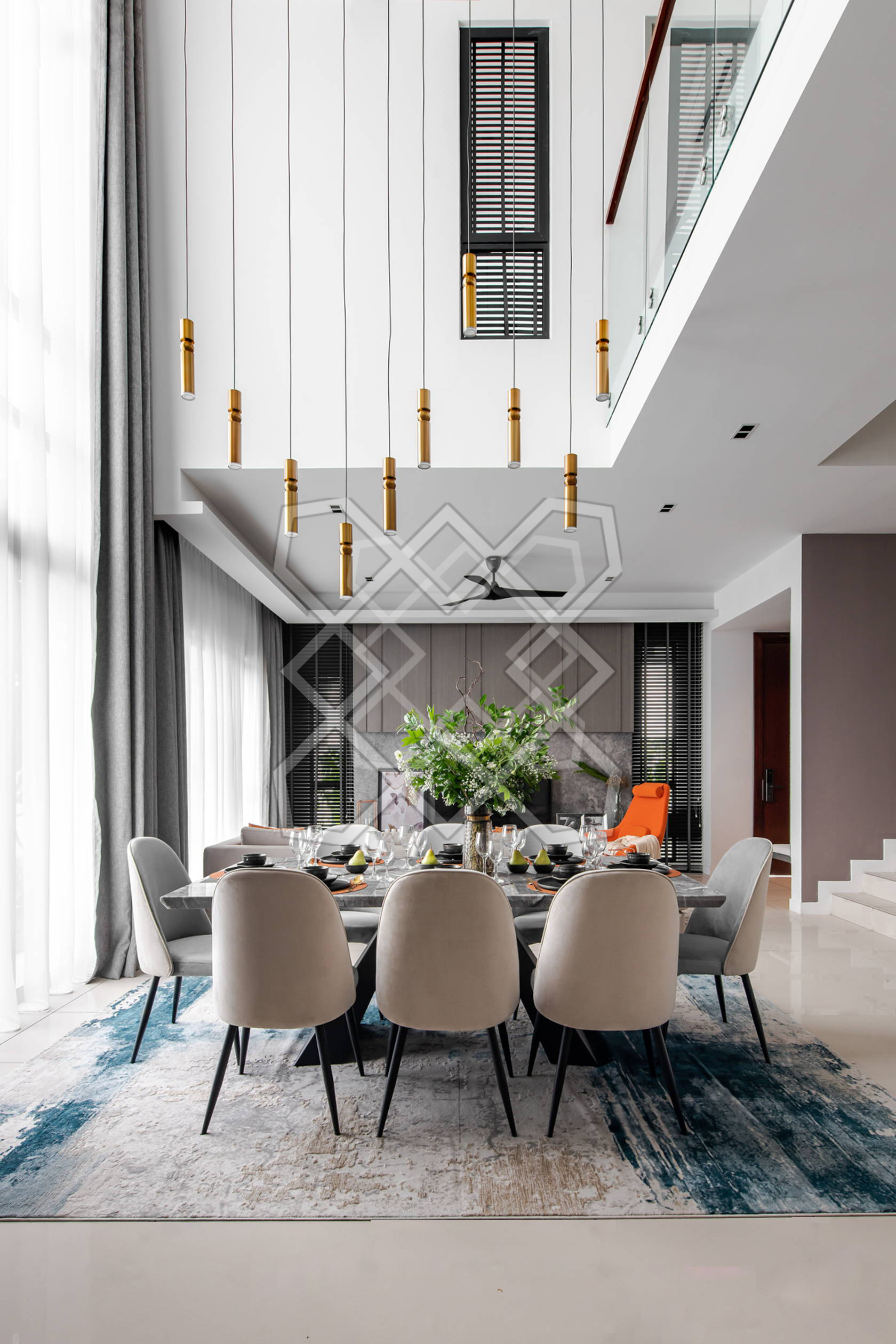 The double-height living volume at A Marvelous Duplex, with its cluster of brass pendants