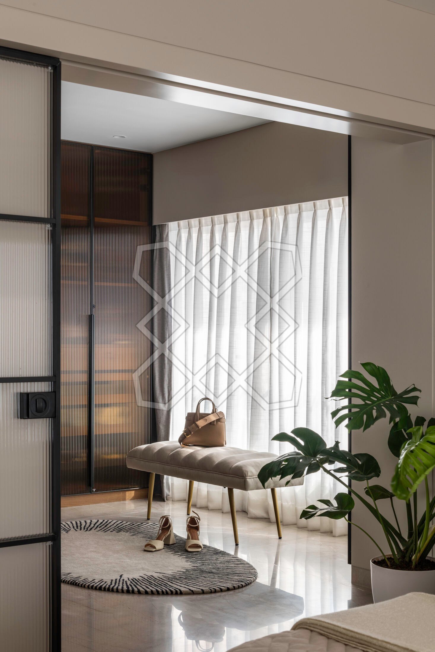 The walk-in wardrobe at the Juhu apartment, behind its fluted glass door