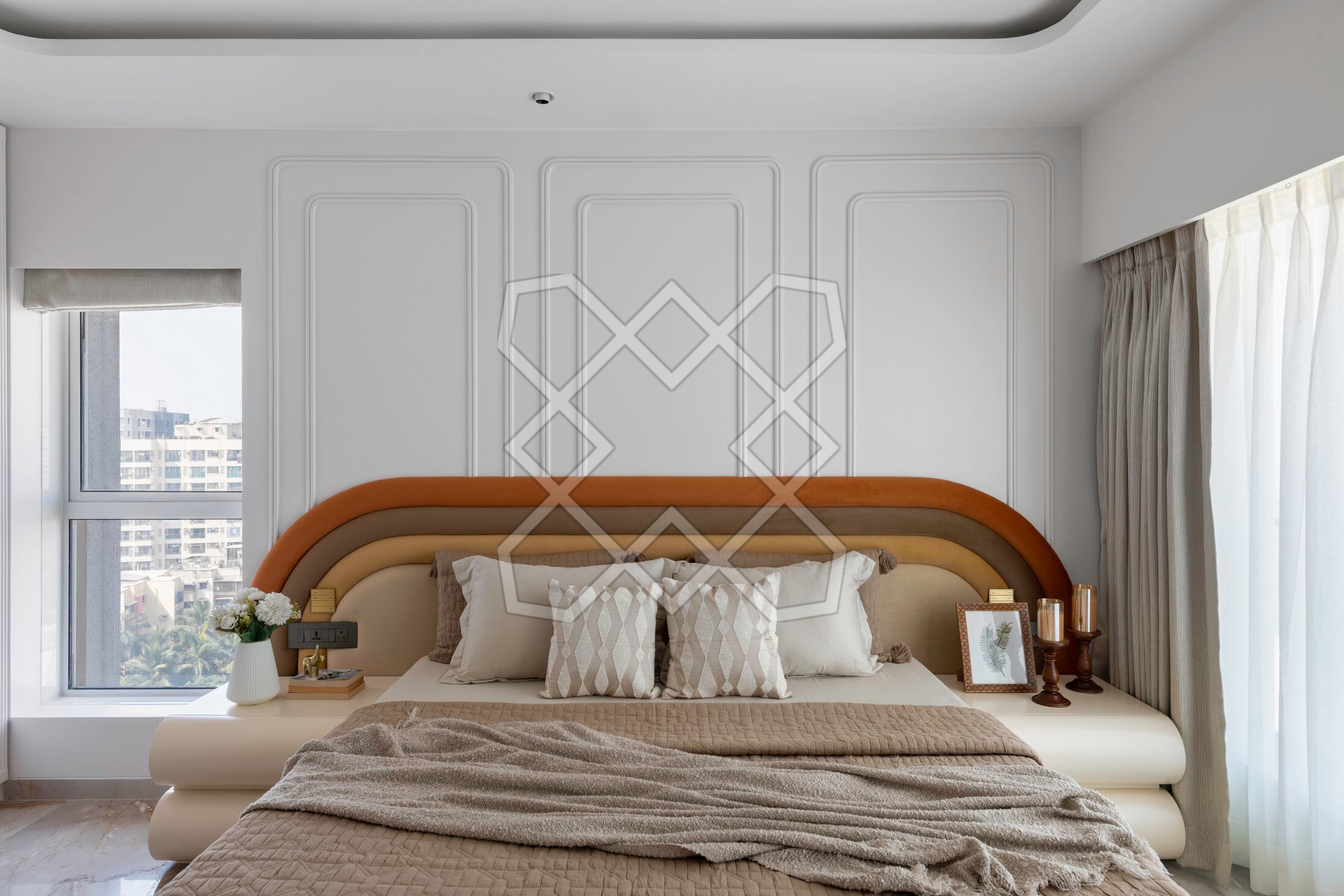 The parents' bedroom at the Juhu apartment, with its rust and ochre bedback