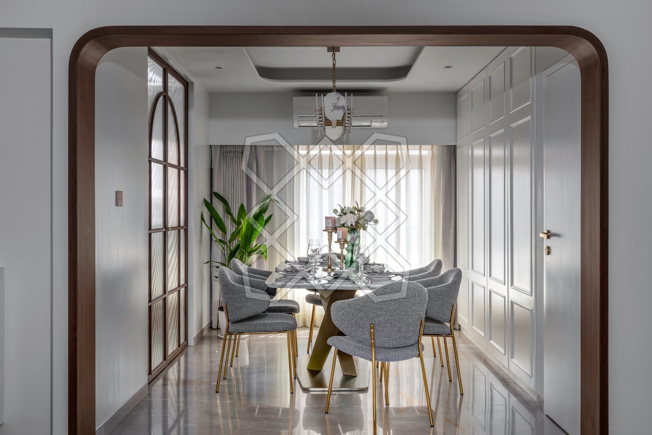 The dining room at the Juhu apartment, entered through its wooden portal