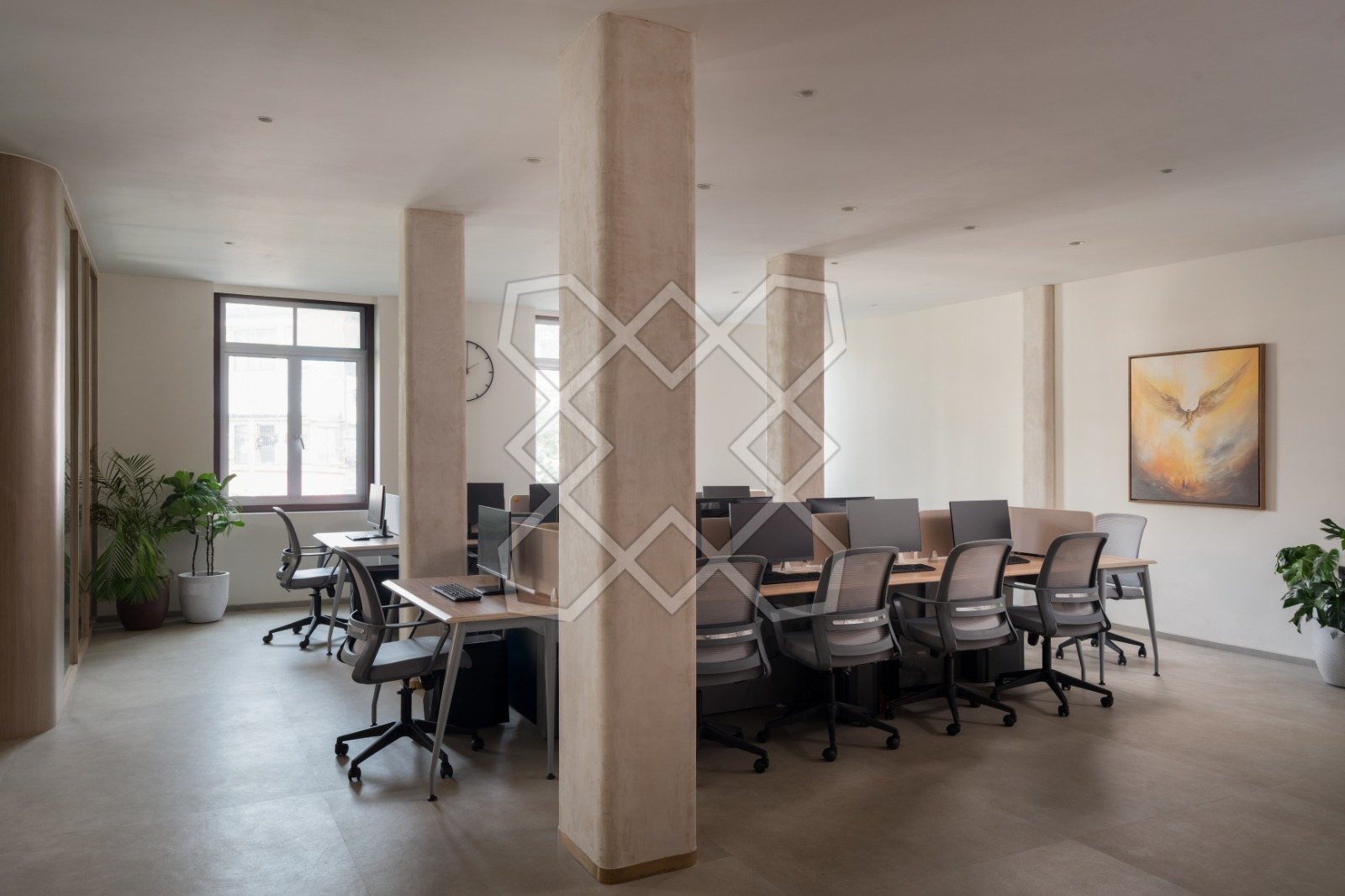 The shared desks at The Genesis, set between the existing columns