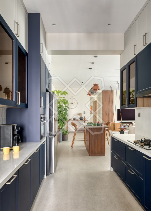 The navy kitchen at Orion, looking through to the dining area
