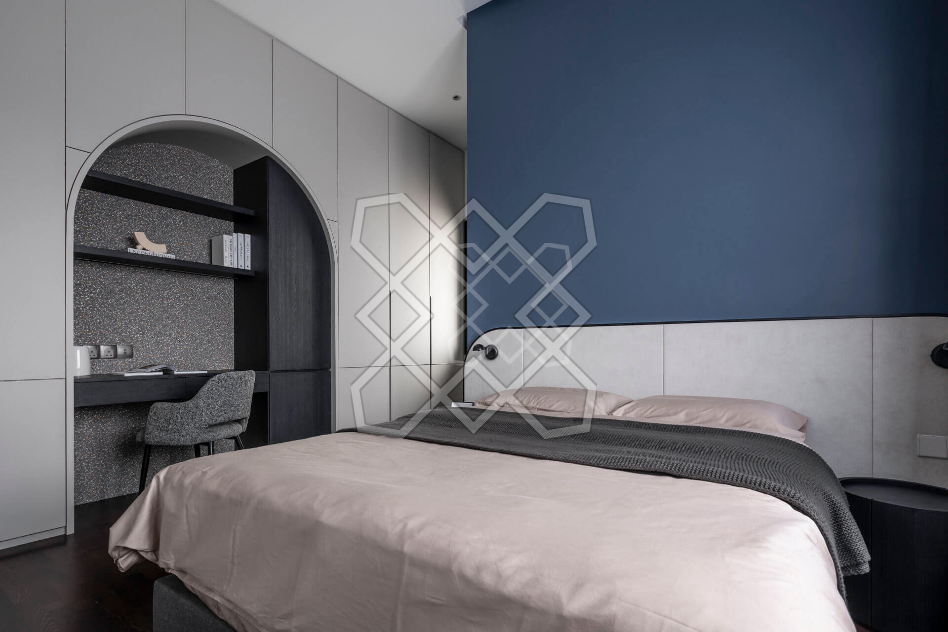 A bedroom at Plush Contemporary House, its blue accent wall beside an arched stone niche