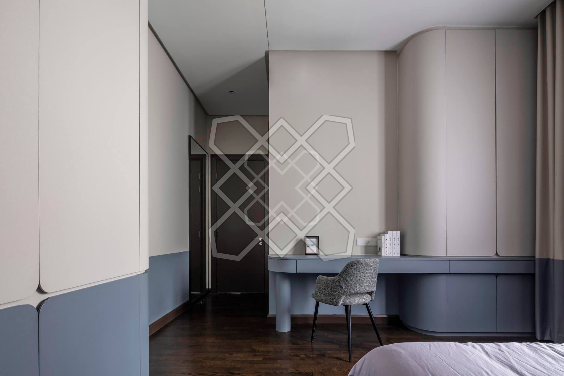 Curved cream joinery and a blue desk at Plush Contemporary House
