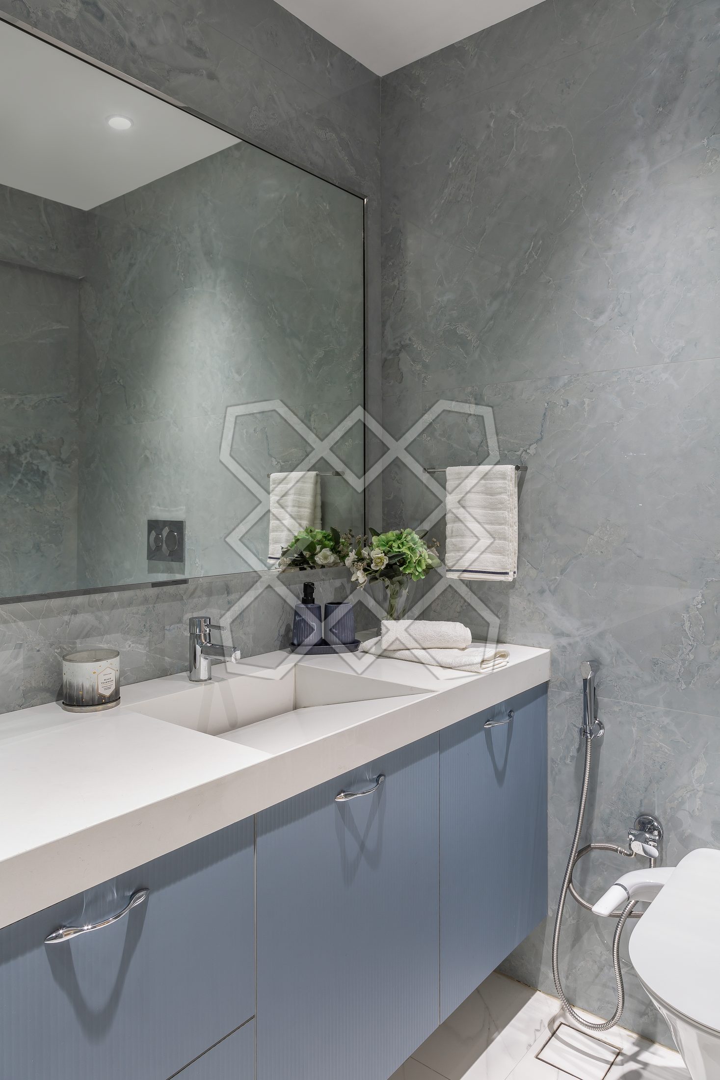 A bathroom at The Eternal Solace, in grey with a blue vanity