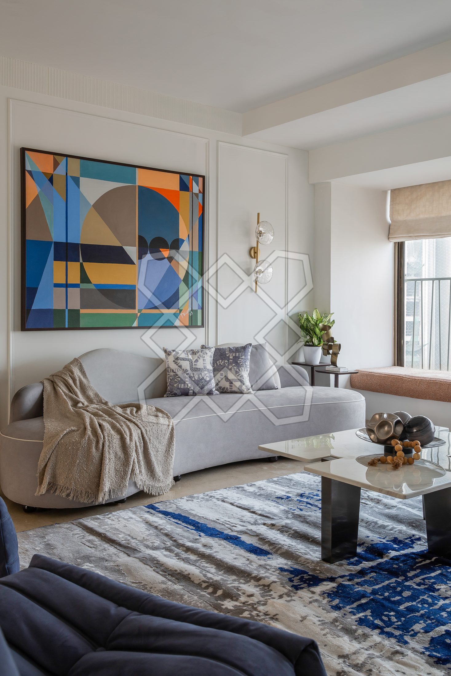 The living room at The Eternal Solace, with its curved sofa and blue lounge chairs