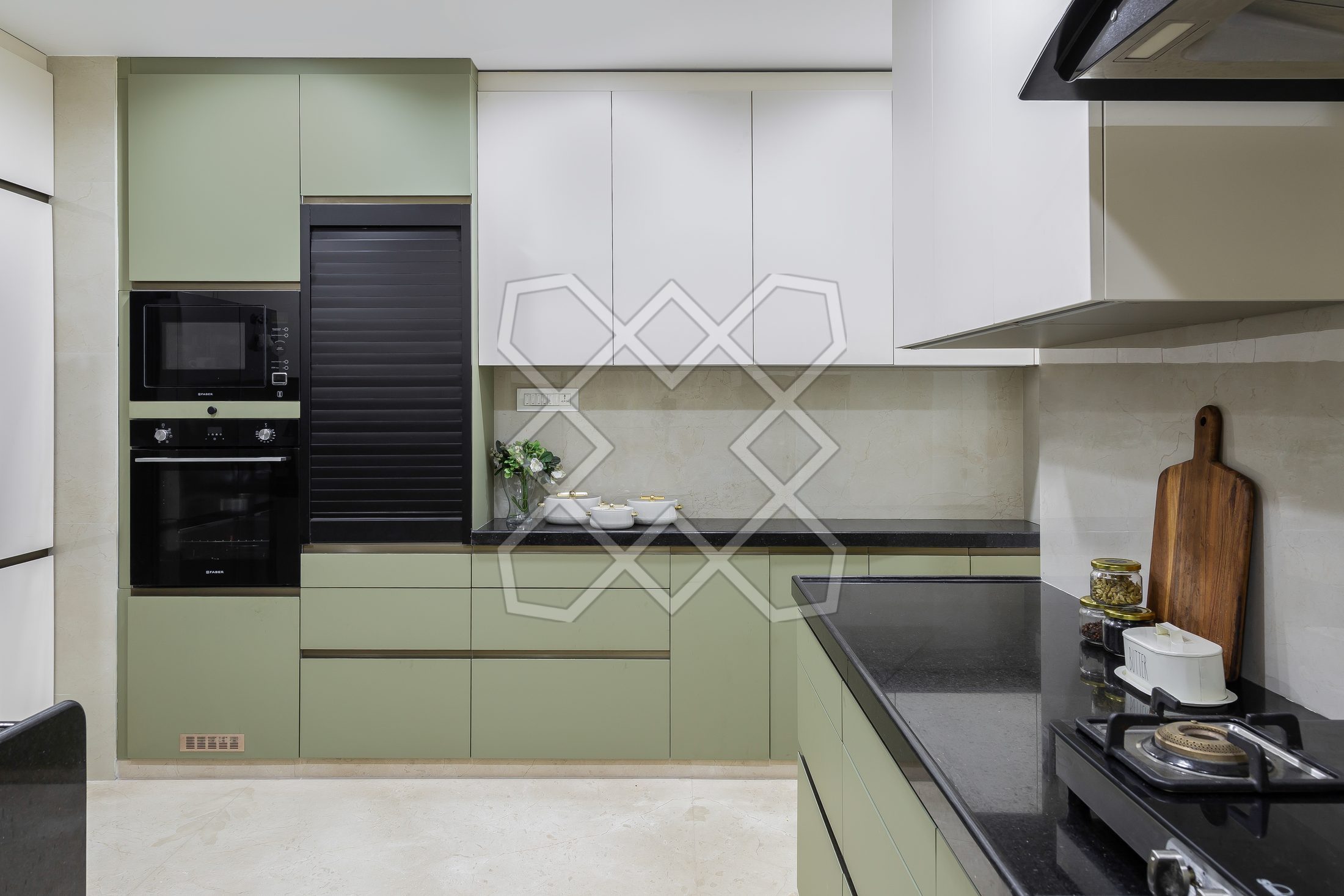 The kitchen at The Eternal Solace, in sage green with a black counter