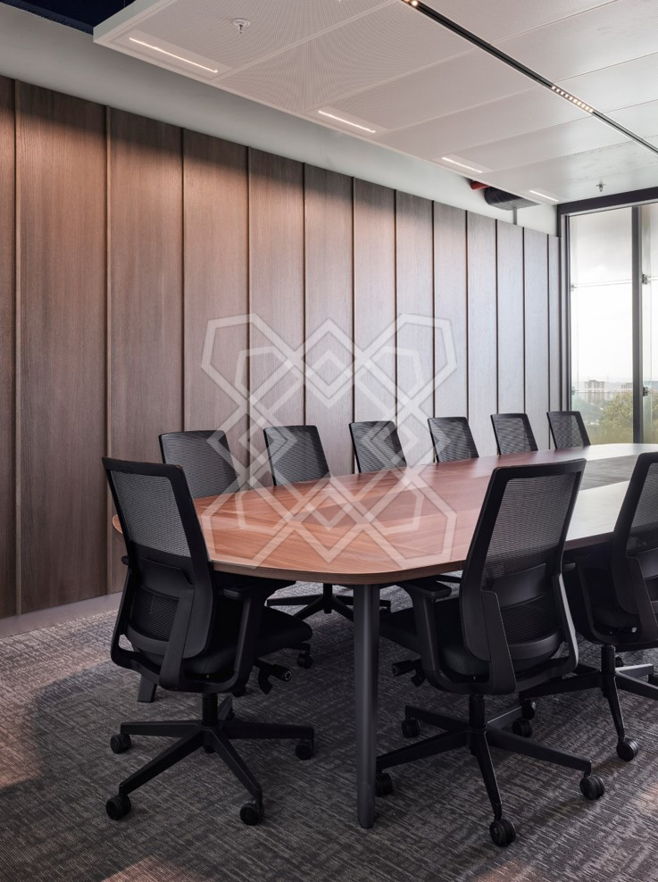 The boardroom at Timeless and Transcendent, under its full-height wall of walnut slats