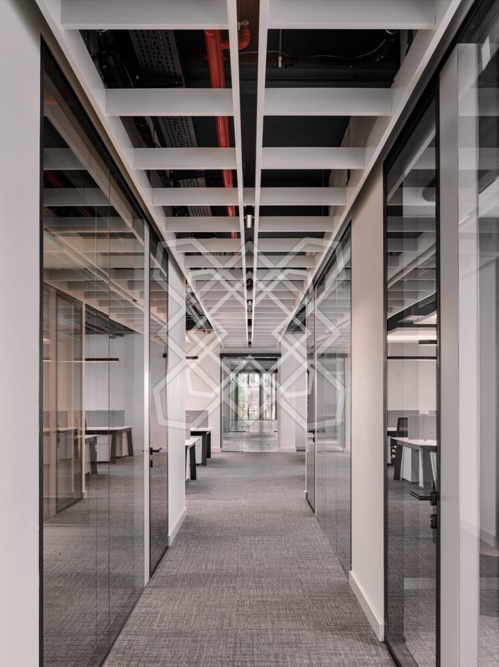 The glazed corridor at Timeless and Transcendent, workstations either side